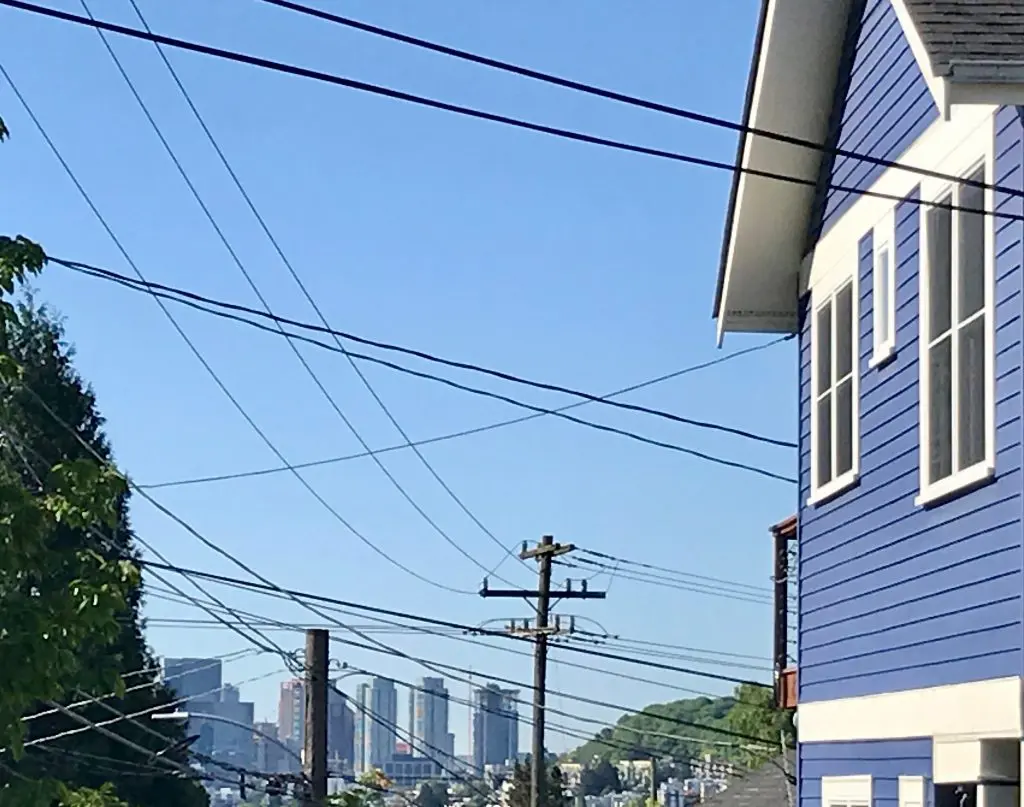 Photo of house showing how overhead wires clutter the sky