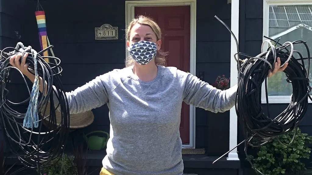 close up of woman holding coil of wires we removed from her home