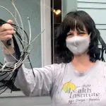 Woman wearing a Covid mask and holding up telecom wires Wire Free Sky removed from her home