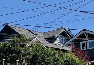 Photo of house showing how overhead wires clutter the sky