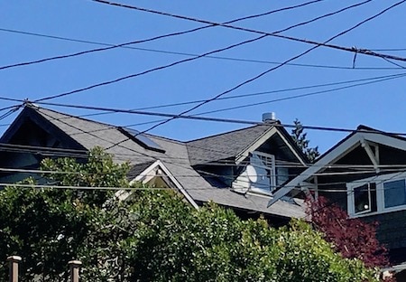 Photo of house showing how overhead wires clutter the sky