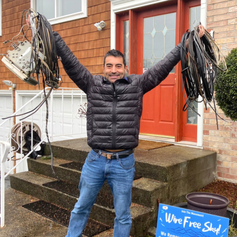 A happy man with celebrating the wire removed from his house